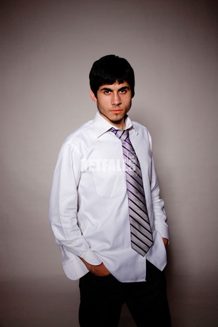 "Businessman putting on tie" stock image