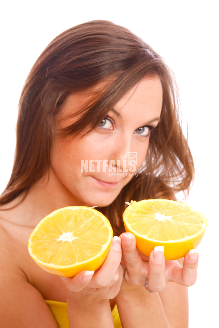 "happy model eating an orange" stock image