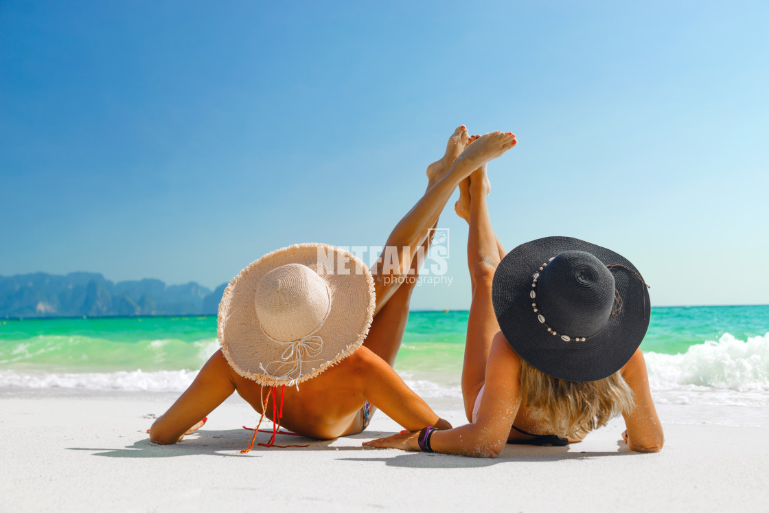 "women sunbathing lying down on the tropical beach" stock image