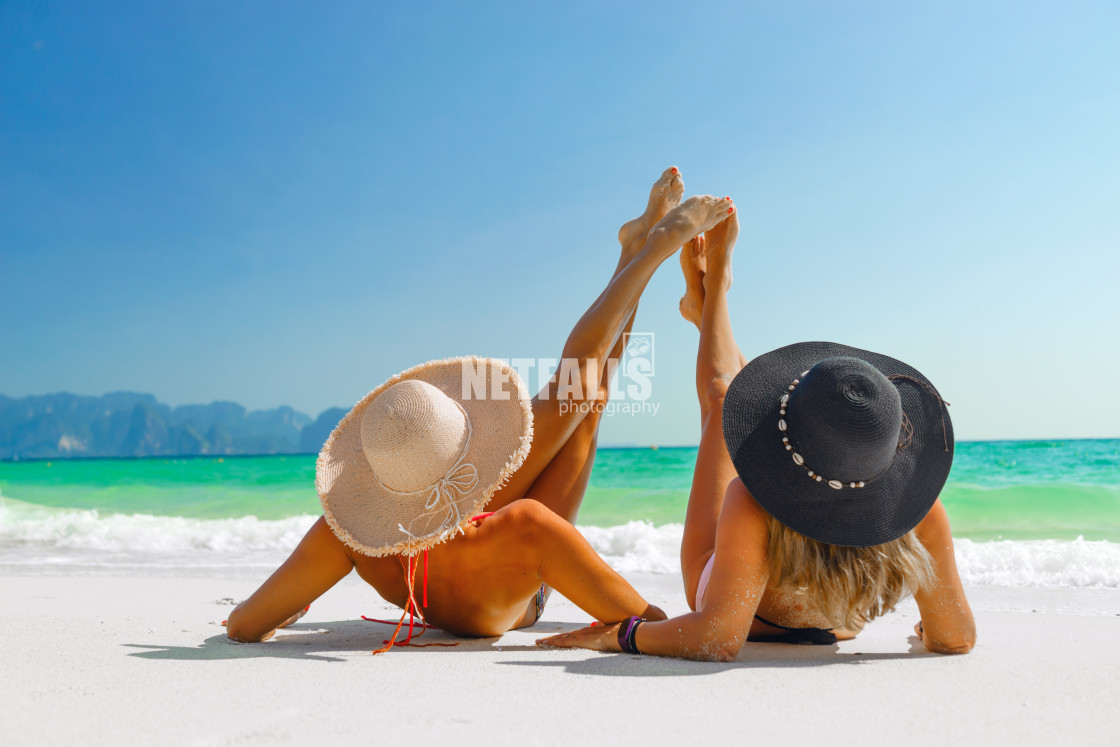 "women sunbathing lying down on the tropical beach" stock image