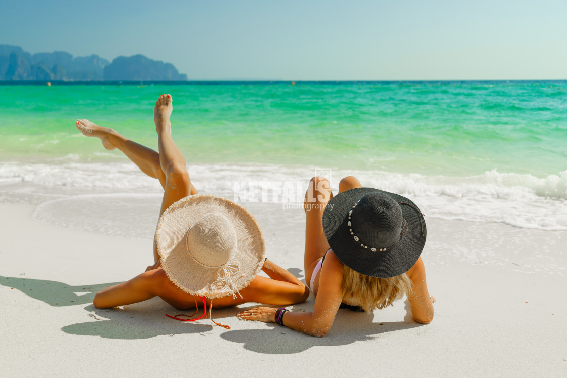 "women sunbathing lying down on the tropical beach" stock image