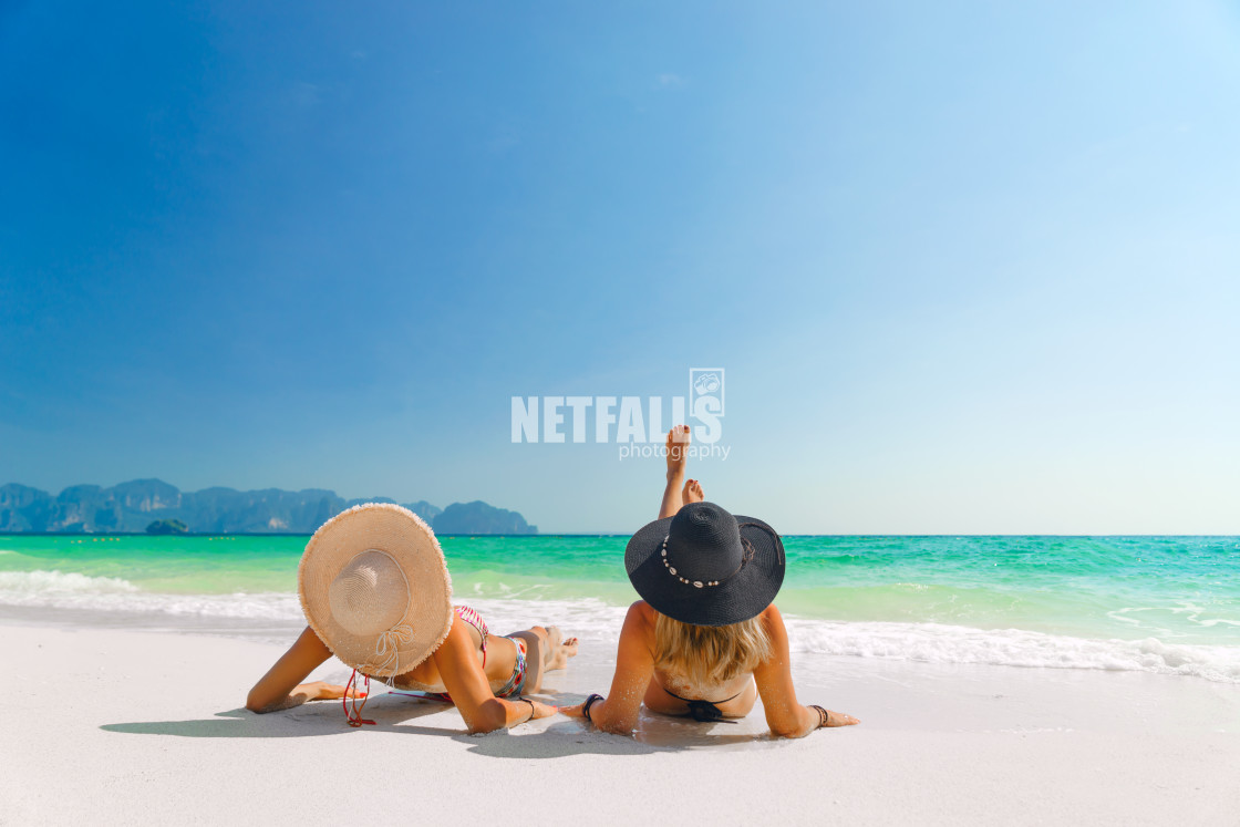 "women sunbathing lying down on the tropical beach" stock image