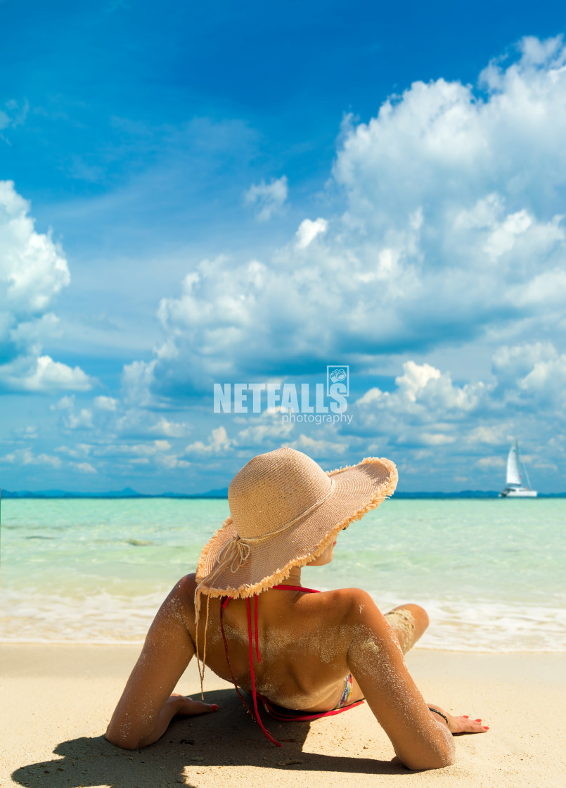 "Beach suntan vacation bikini woman lying down tanning under tropical sun in..." stock image