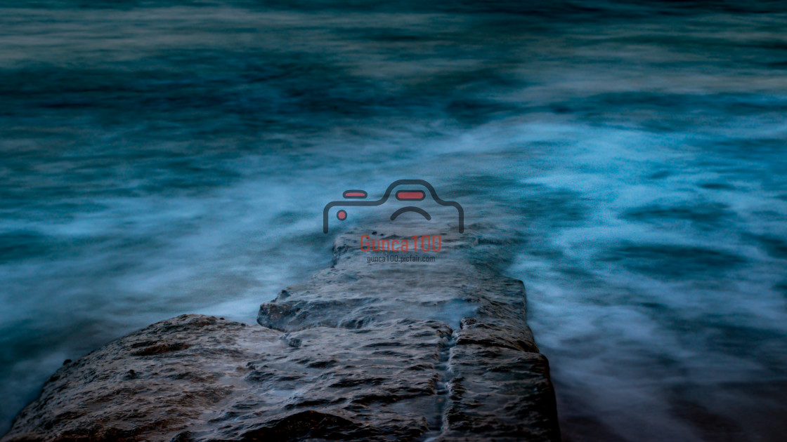 "Long exposure of water covering rock" stock image