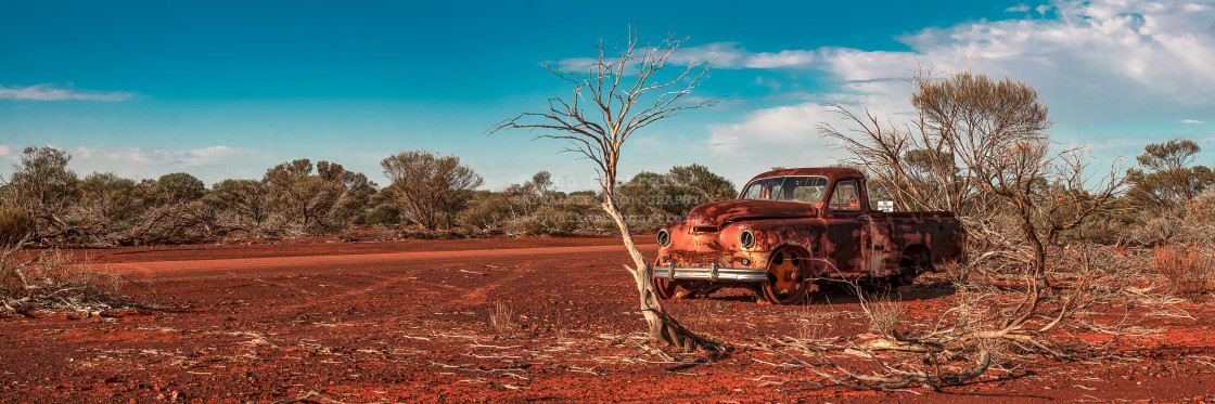 "Rusty Ute in red dirt in the Aussie Outback panorama" stock image