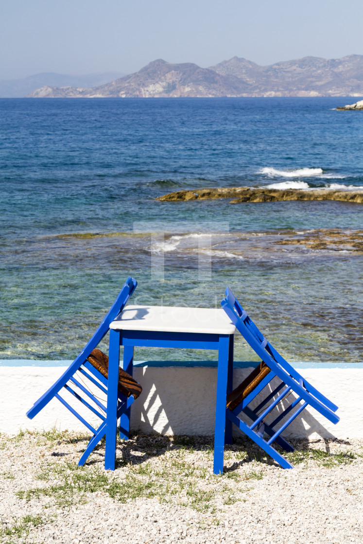 "Painted chairs and table by the sea" by TTStock - $7.54 "Painted chairs and table by the sea" stock image