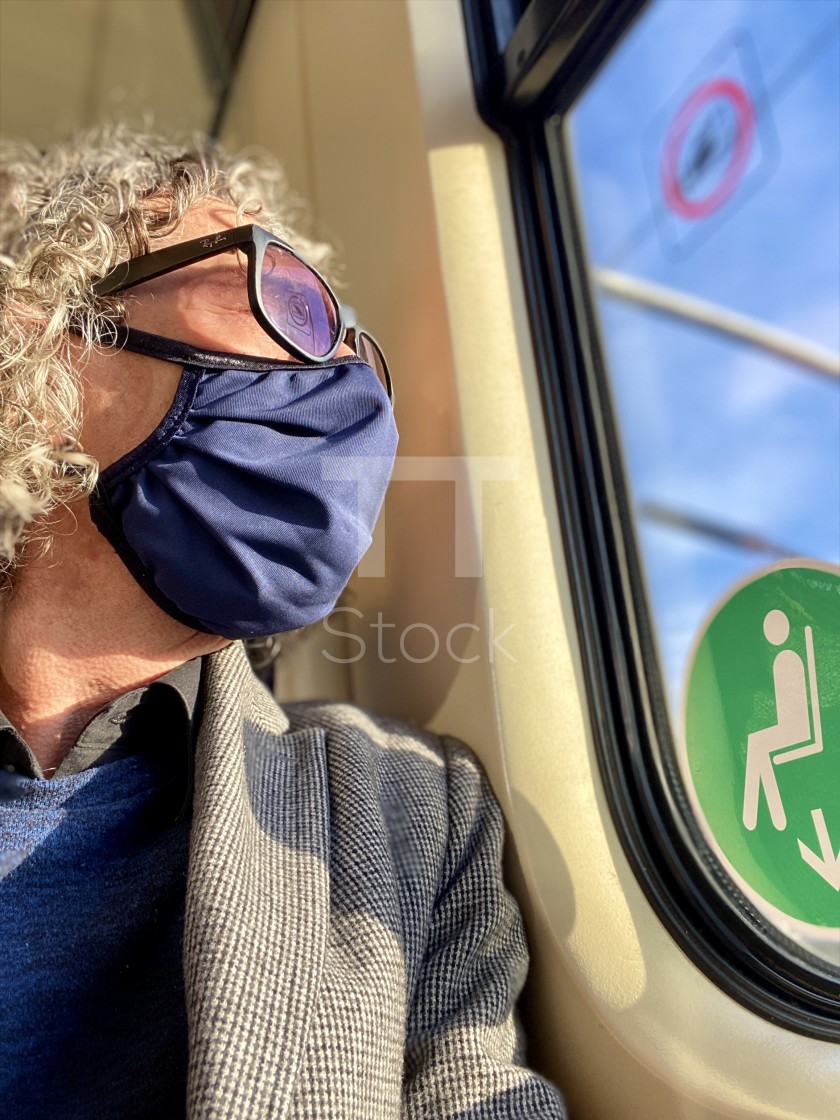 "Mature older man traveling on a commuter train during Corona epidemic wearing washable face mask." by TTStock - £14.99 "Mature older man traveling on a commuter train during Corona epidemic wearing washable face mask." stock image
