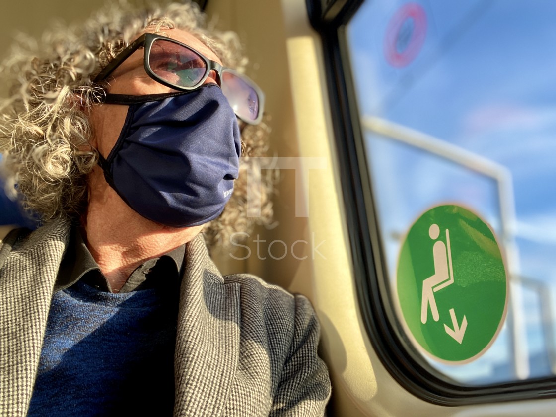 "Mature older man traveling on a commuter train during Corona epidemic wearing washable face mask." by TTStock - £14.99 "Mature older man traveling on a commuter train during Corona epidemic wearing washable face mask." stock image