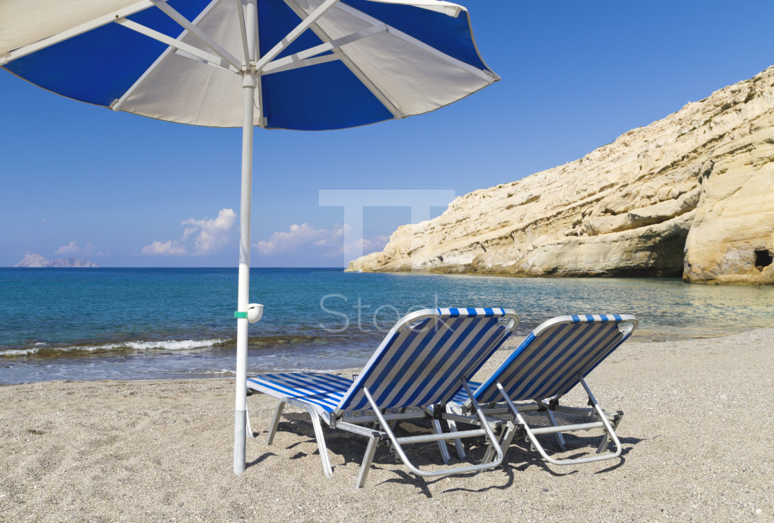 "Two sunbeds and a parasol" by TTStock - $7.46 "Two sunbeds and a parasol" stock image