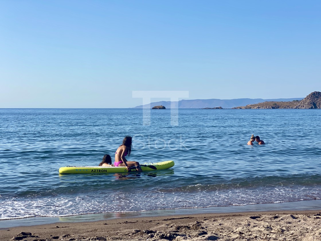 "Young woman wearing a pink bikini sitting relaxing with friend sup board at sea." by TTStock - $7.46 "Young woman wearing a pink bikini sitting relaxing with friend sup board at sea." stock image