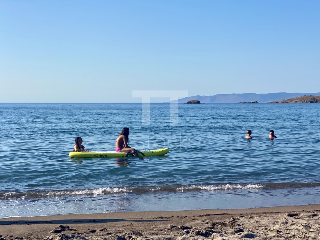 "Young woman wearing a pink bikini sitting on a yellow sup board at sea." by TTStock - $7.46 "Young woman wearing a pink bikini sitting on a yellow sup board at sea." stock image