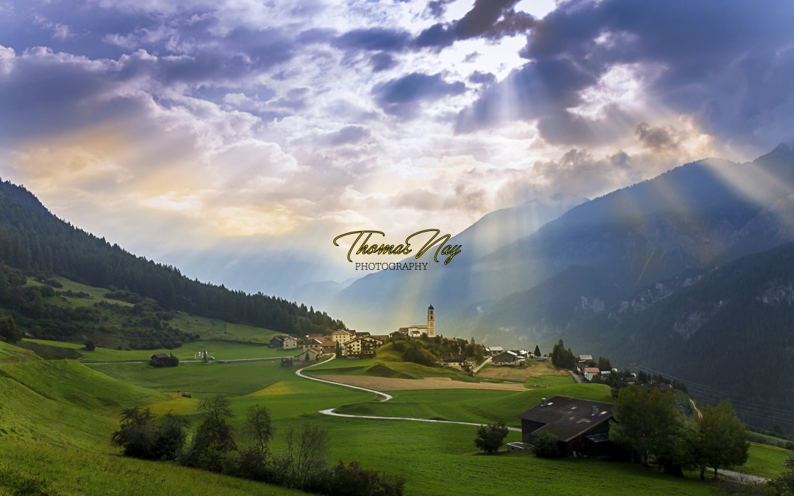 "tne morning sun breaks through the clouds over the village Brienz in Graubuenden, Switzerland" by Thomas Nay - £11.50 "tne morning sun breaks through the clouds over the village Brienz in Graubuenden, Switzerland" stock image