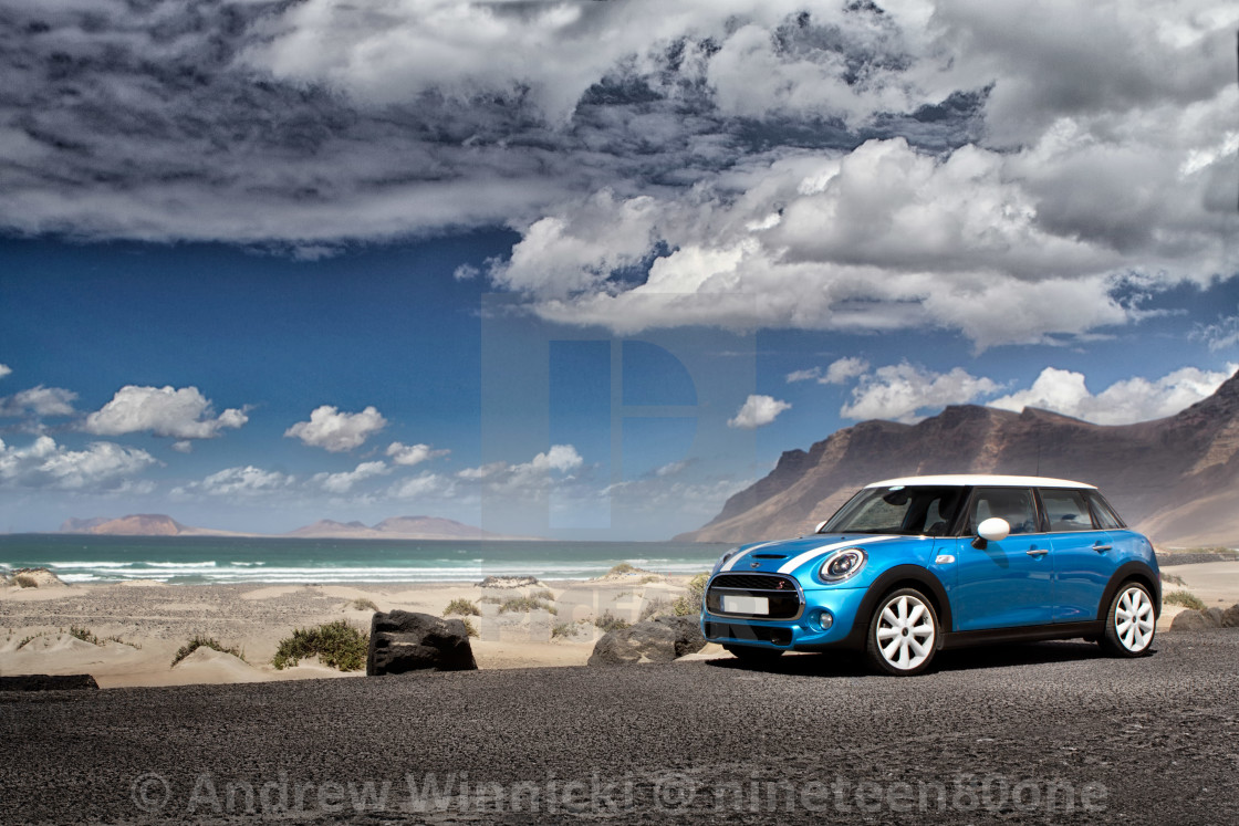 "A small city car on a beach on holiday island" stock image