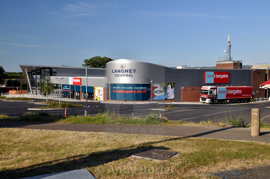 "shopping centre on a sunny morning with home bargains delivery truck. Langney Shopping Centre, Eastbourne, England. Early sunny morning with almost empty car park." stock image