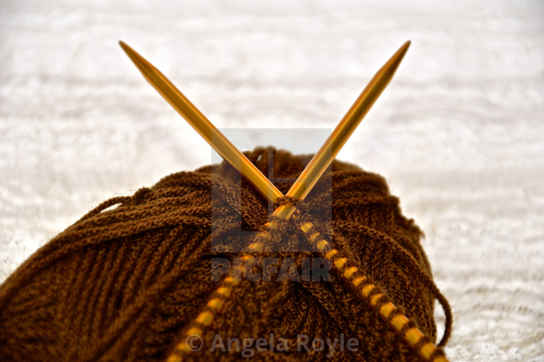 "Close up of brown wool and knitting." stock image