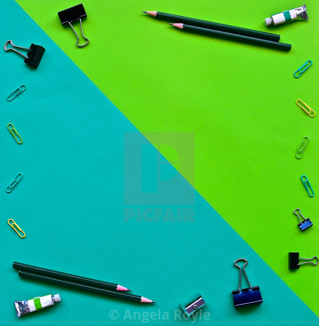 "Flatlay of office items on a green background." stock image