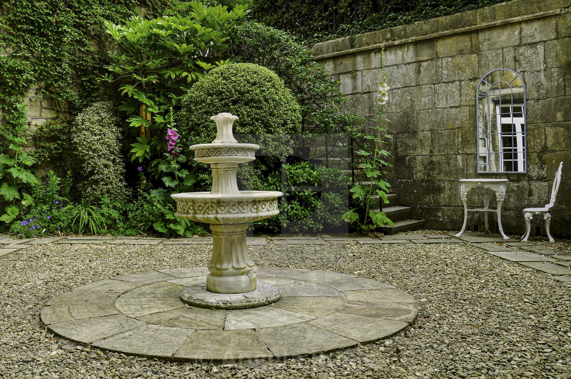 "English cottage garden with water feature" stock image