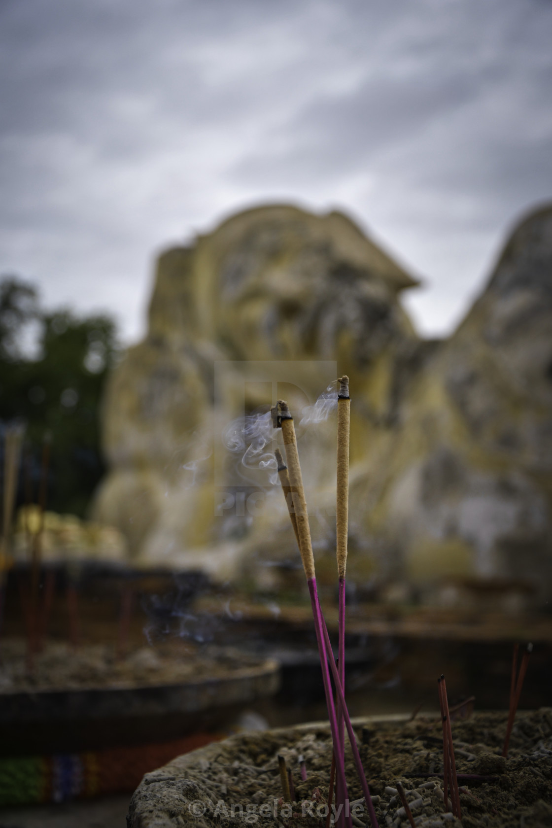 "Incense sticks and a reclining buddha" stock image