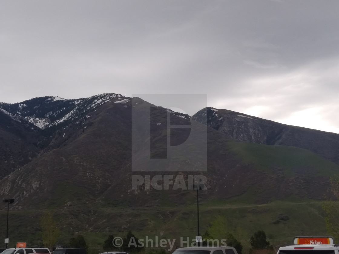 "Dark clouds coming from over the mountains" by Ashley Harms - $38.38 "Dark clouds coming from over the mountains" stock image