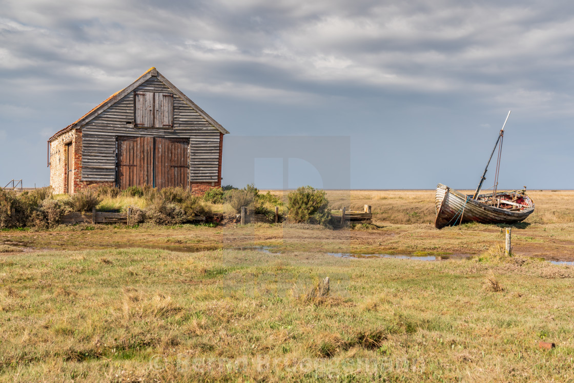 "A barn and a boat in Thornham Old Harbour, Norfolk, England" stock image