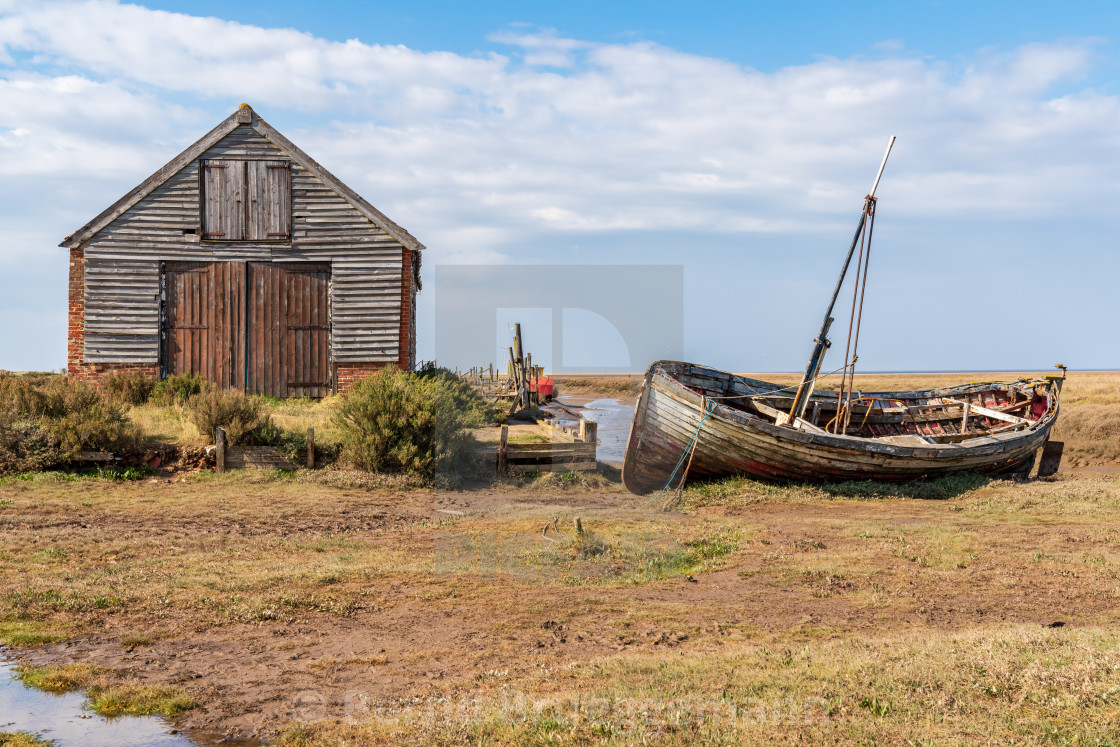 "A barn and a boat in Thornham Old Harbour, Norfolk, England" stock image