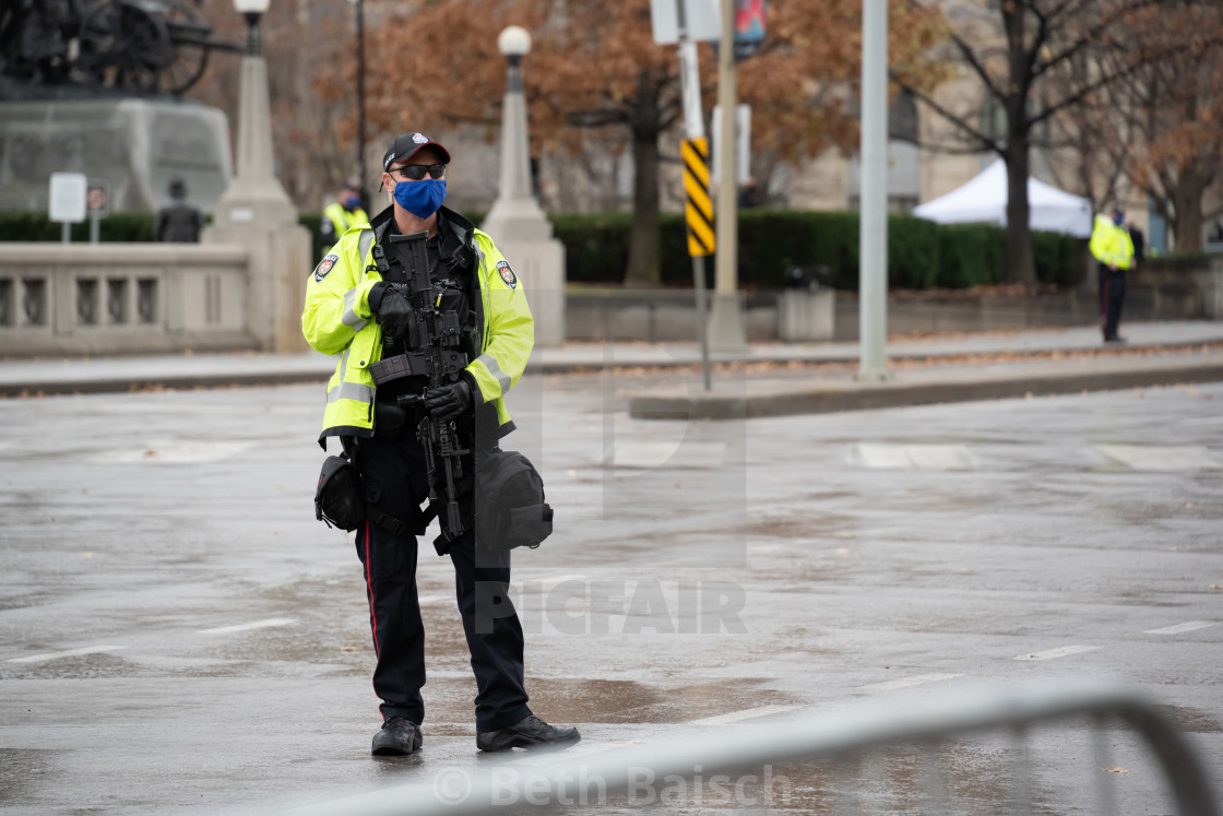 "Policeman Keeps Spectators Away From Remembrance Day Ceremony in Ottawa, Canada." by Beth Baisch - $12.33 "Policeman Keeps Spectators Away From Remembrance Day Ceremony in Ottawa, Canada." stock image