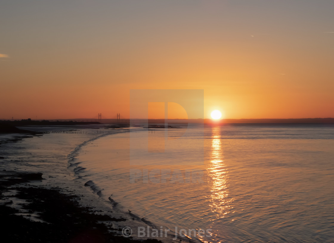 "The Prince of Wales bridge at sunrise taken from Goldcliff Seawall" stock image