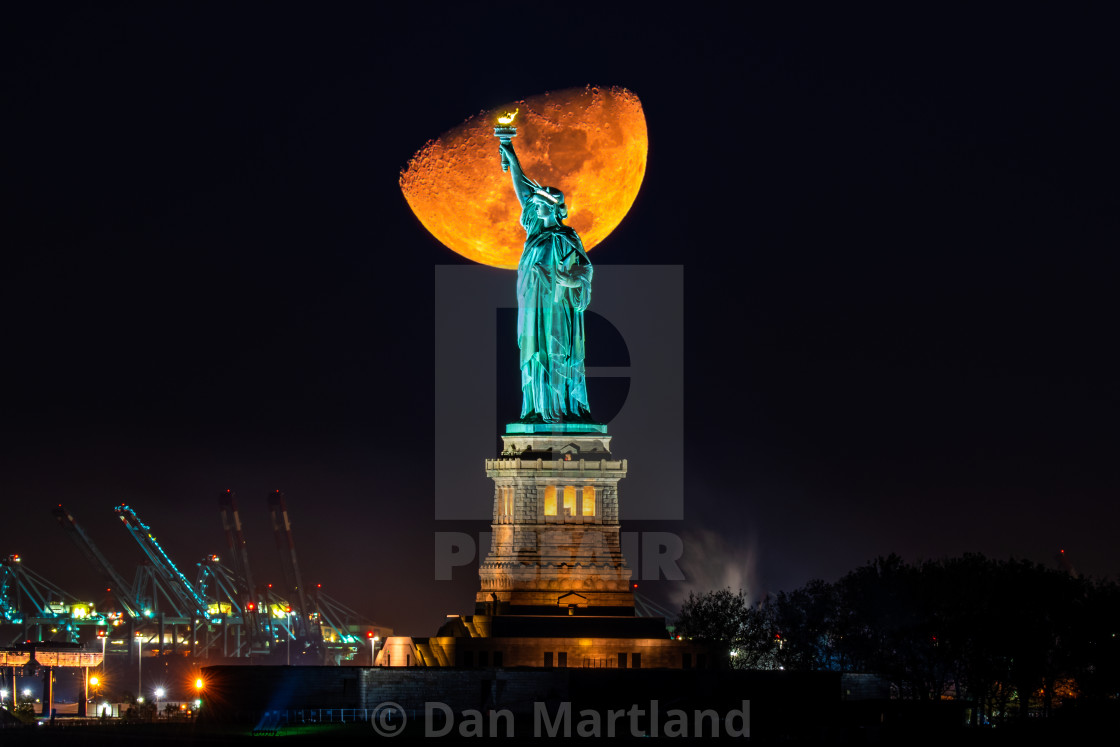 "Moon Set Behind Statue Of Liberty" stock image