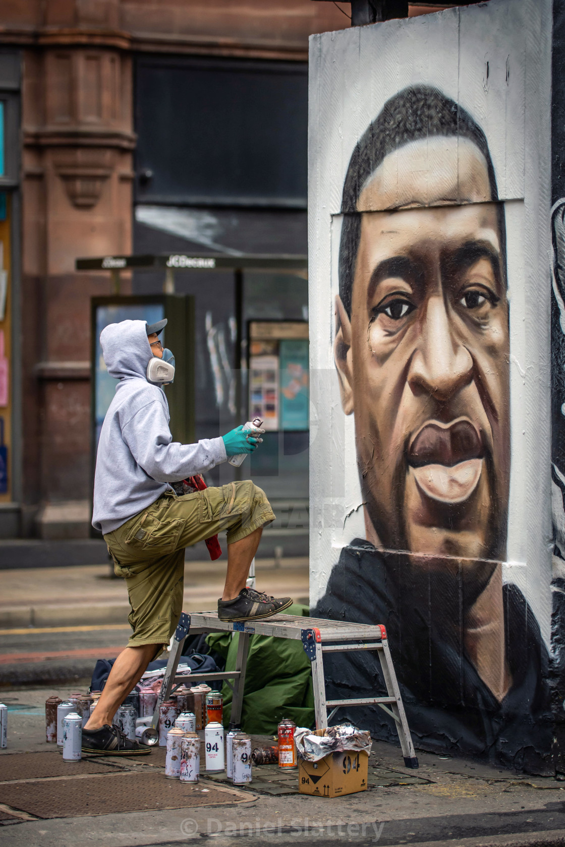 "Graffiti Artist Akse, painting a mural of Floyd George" stock image