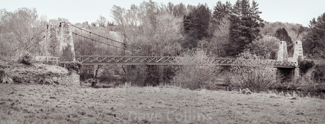 "Monochrome panorama of the Kalemouth Suspension Bridge over the Teviot river between Kelso and Jedburgh in the Scottish Borders, UK." stock image