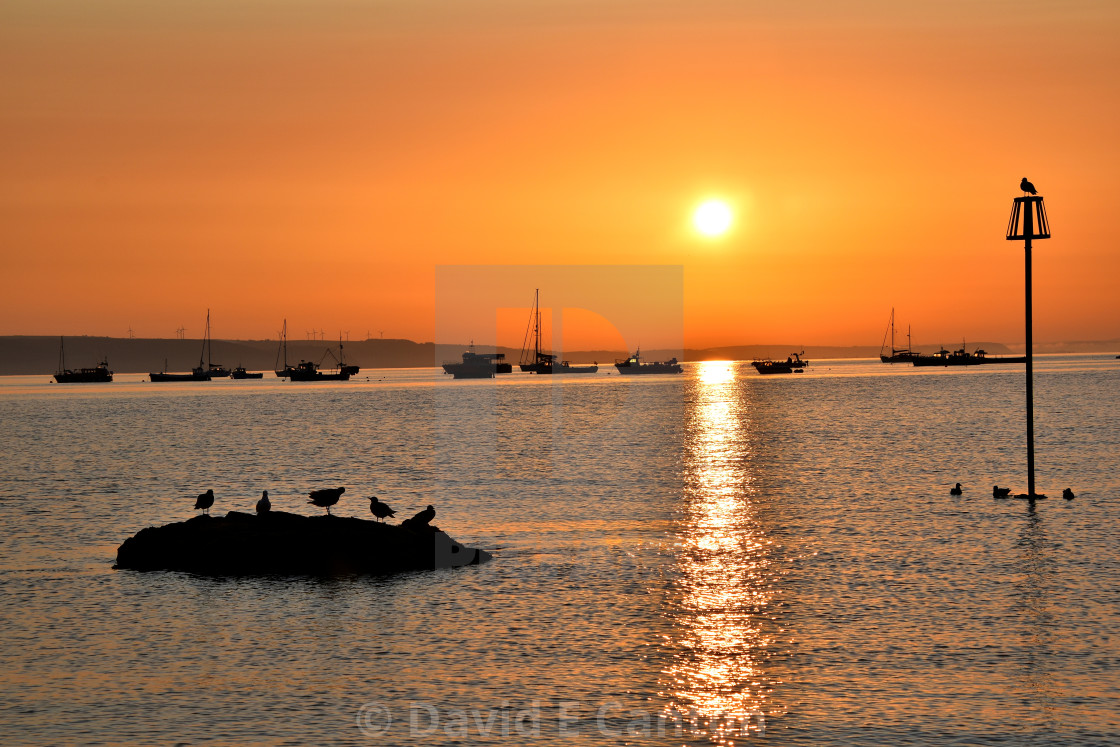 "Tenby at sunrise" stock image