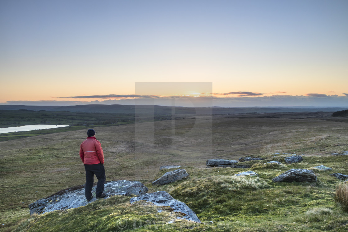 "A Walker Enjoying the View over Baldersdale just before Sunrise" stock image