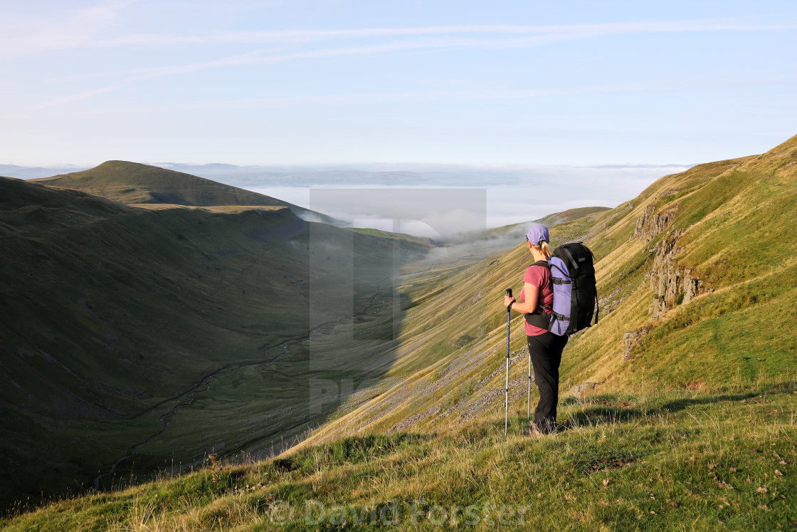 "Backpacker Enjoying the View over High Cup, Cumbria, UK" stock image