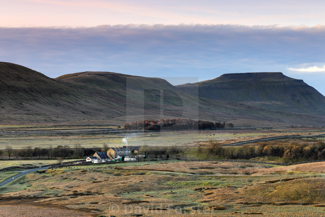 "Ingleborough and Simon Fell with the Station Inn in the foreground, viewed from Runscar Scar, Yorkshire Dales, UK" stock image