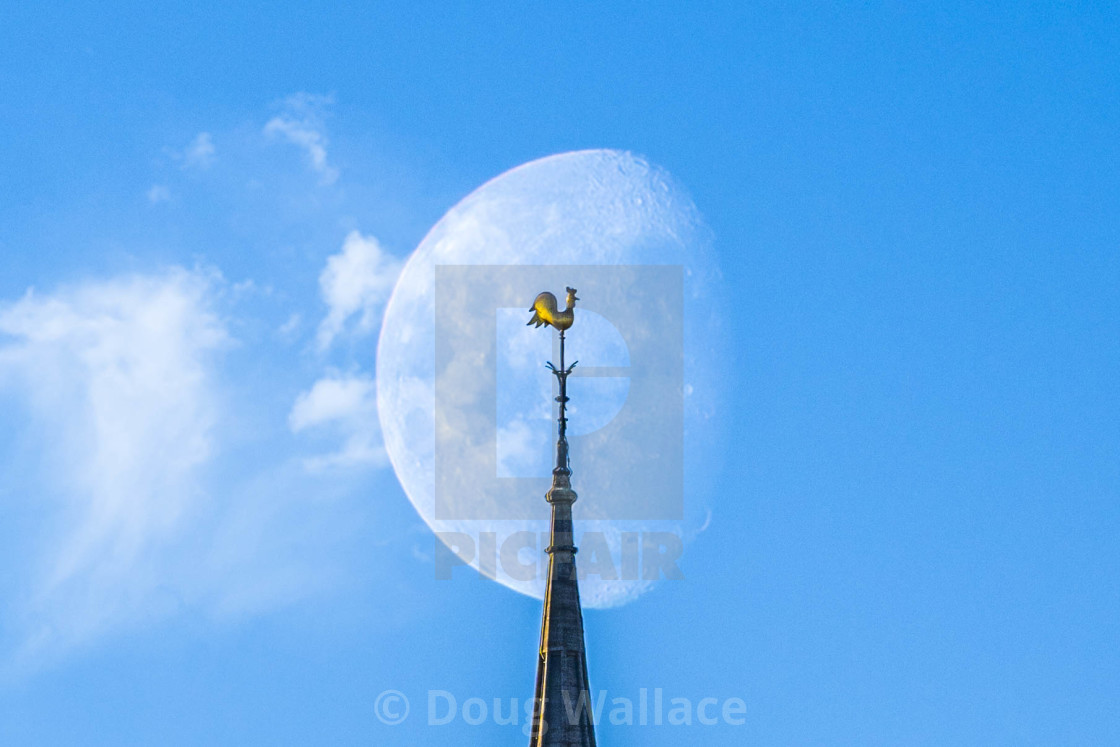 "Moonset, Sunrise on Spire of the Catholic Church, Cambridge UK." stock image