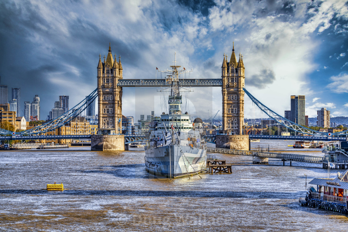 "HMS Belfast moored on the River Thames with London Bridge in the background." stock image