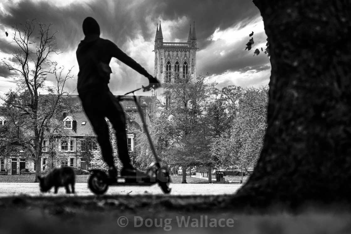 "Black and White silhouettes of a man on a scooter. Picture taken from Jesus Green, Cambridge UK." stock image