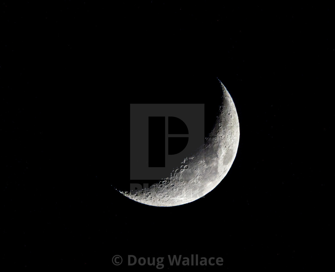 "Waxing Crescent Moon, 27% visible." stock image