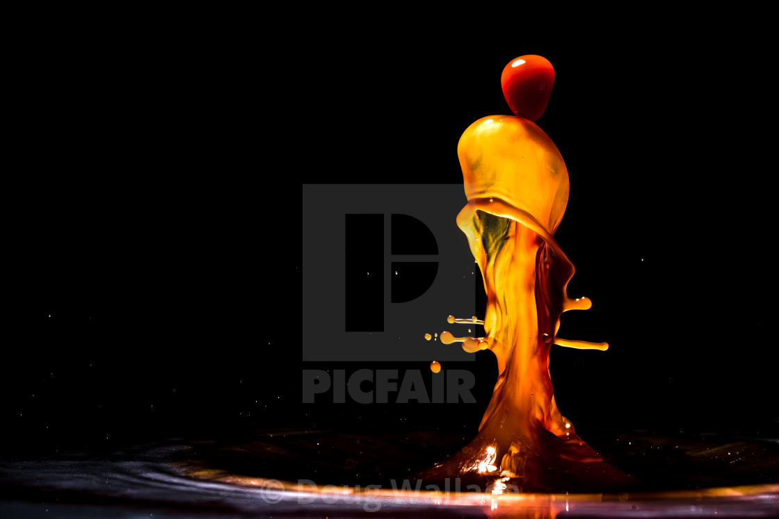 "Coloured waterdrops making patterns." stock image