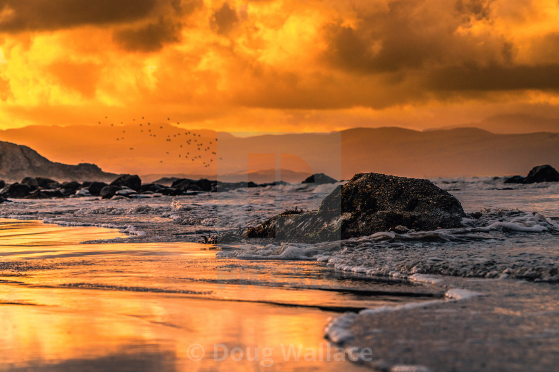 "Sunrise from Criccieth beach, Wales UK." stock image