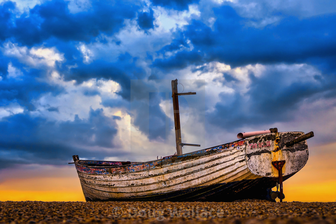 "An abandoned boat at sunset, Aldeburgh beach, Suffolk, UK." stock image