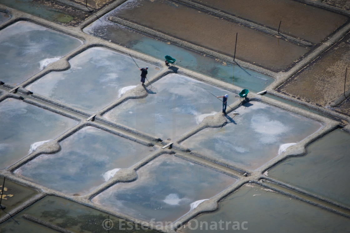 "Saltfarmers working in the saline" by Estefano Onatrac - $12.35 "Saltfarmers working in the saline" stock image