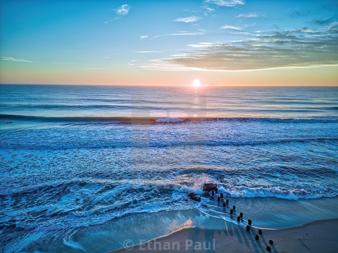 "New years Day Sunrise with SurfNew years Day Sunrise with Jetty" by Ethan Paul - $31.75 "New years Day Sunrise with SurfNew years Day Sunrise with Jetty" stock image