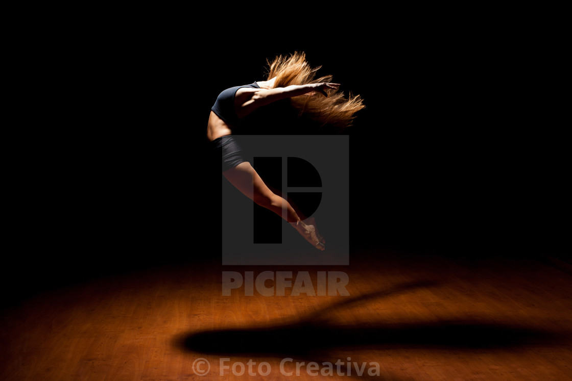 "Beautiful dancer jumping in a stage" by Foto Creativa - £3.80 "Beautiful dancer jumping in a stage" stock image