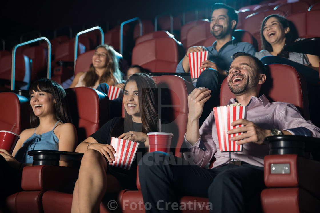 "Group of people laughing at the movie theater" by Foto Creativa - £3.80 "Group of people laughing at the movie theater" stock image