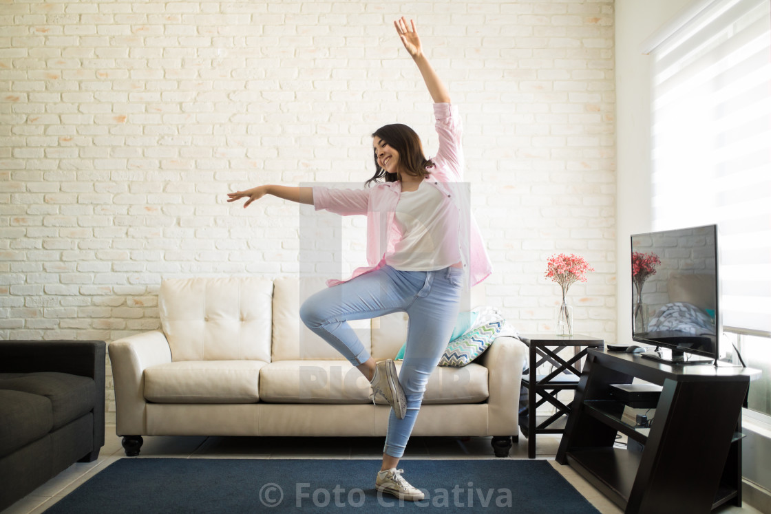 "Single woman dancing in the new apartment" by Foto Creativa - £3.80 "Single woman dancing in the new apartment" stock image
