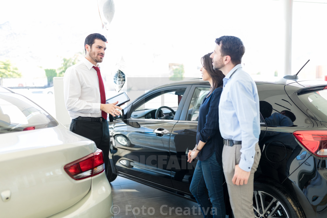 "Couple Listening To Car Salesman With Trust" by Foto Creativa - £3.80 "Couple Listening To Car Salesman With Trust" stock image