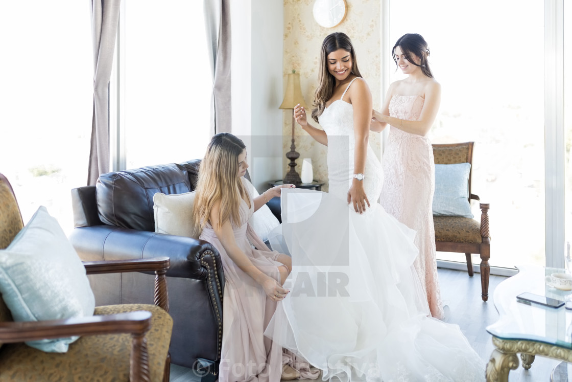 "Pleasant Women Helping Friend Getting Ready For Her Marriage" by Foto Creativa - £3.80 "Pleasant Women Helping Friend Getting Ready For Her Marriage" stock image