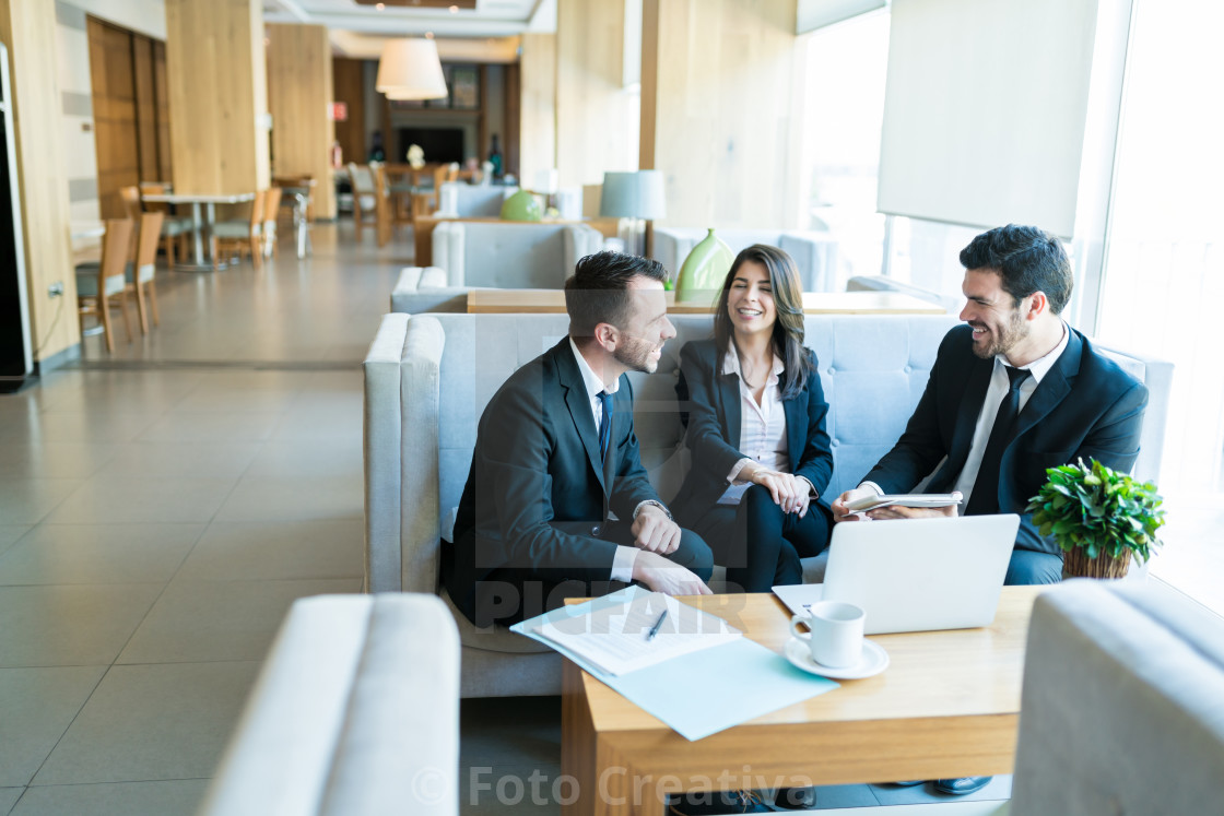 "Mid Adult Professionals Sharing A Light Moment In Lobby" by Foto Creativa - £3.80 "Mid Adult Professionals Sharing A Light Moment In Lobby" stock image