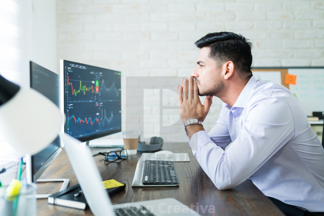 "Attractive Male Finance Professional Concentrating On Trading" by Foto Creativa - £3.80 "Attractive Male Finance Professional Concentrating On Trading" stock image